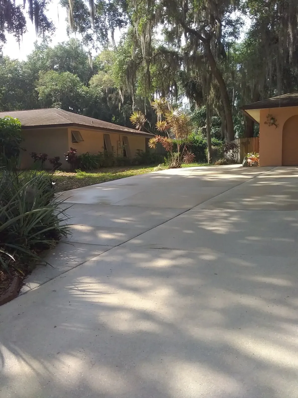 A cleaned concrete driveway in even pale grey