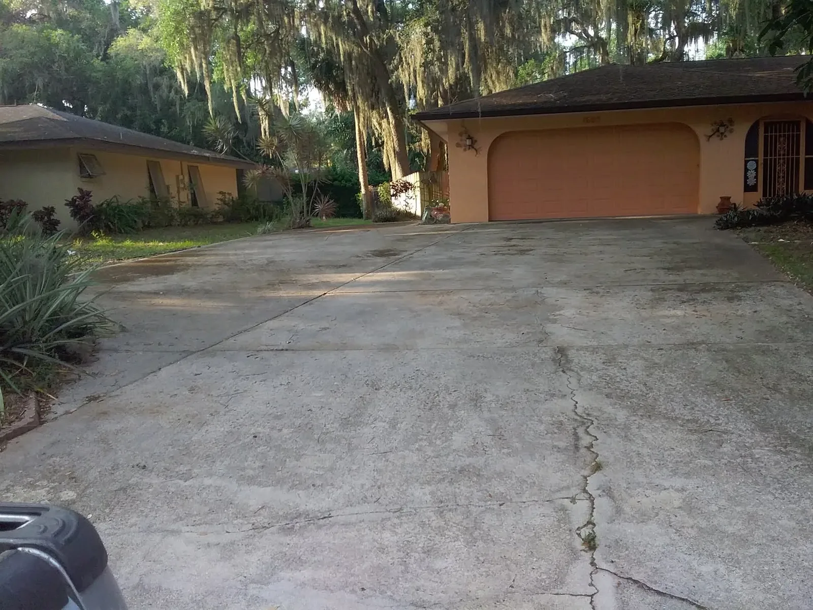 Concrete driveway darkened with black staining and tyre marks