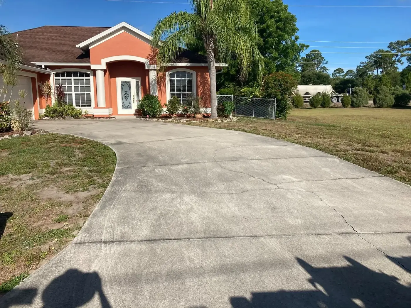 Home driveway and entry path stained dark along the edges and joints